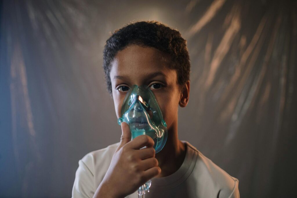 a boy in white shirt holding green oxygen mask
TRYPONOSOMIASIS 