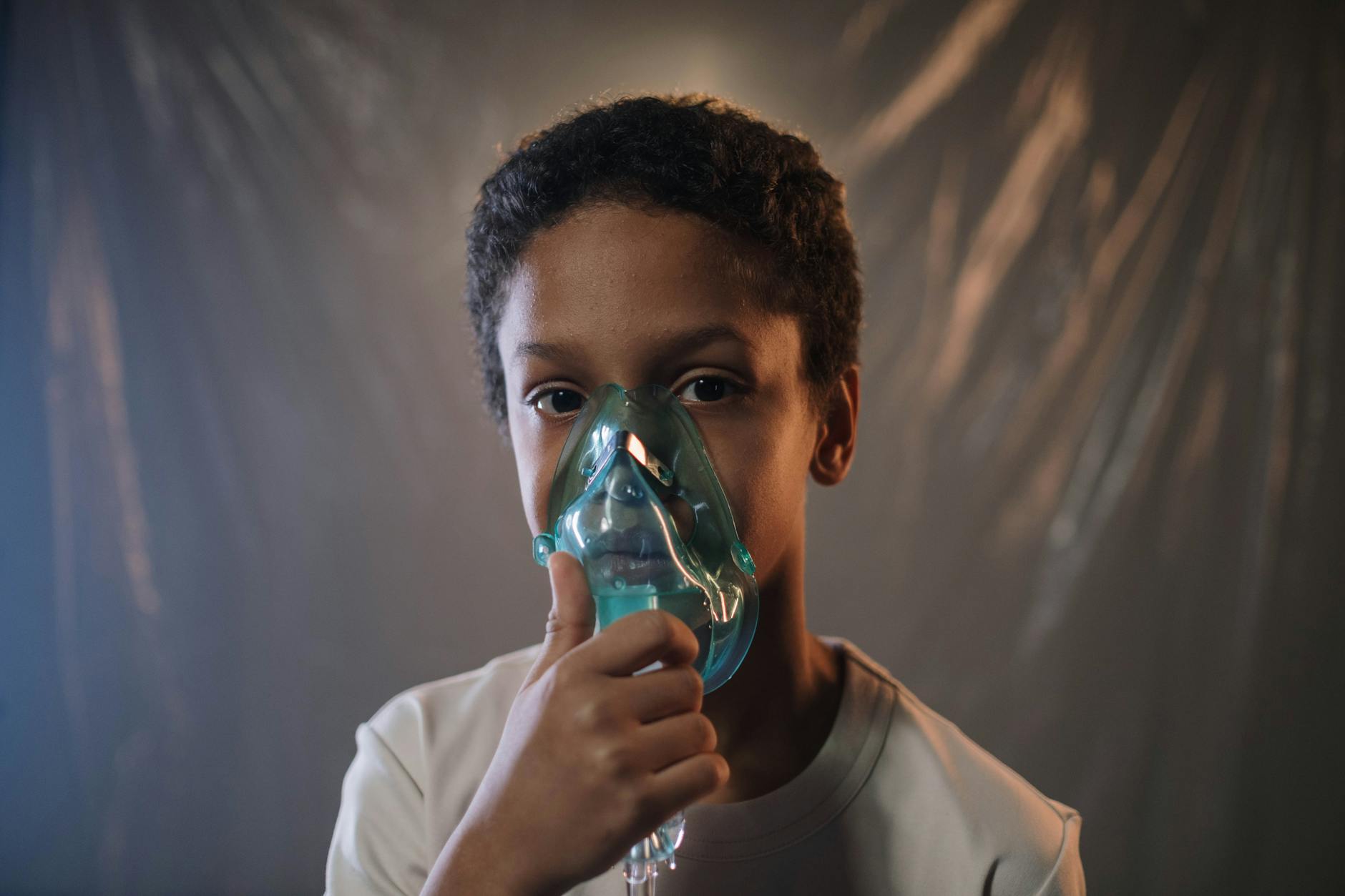 a boy in white shirt holding green oxygen mask
respiratory system 